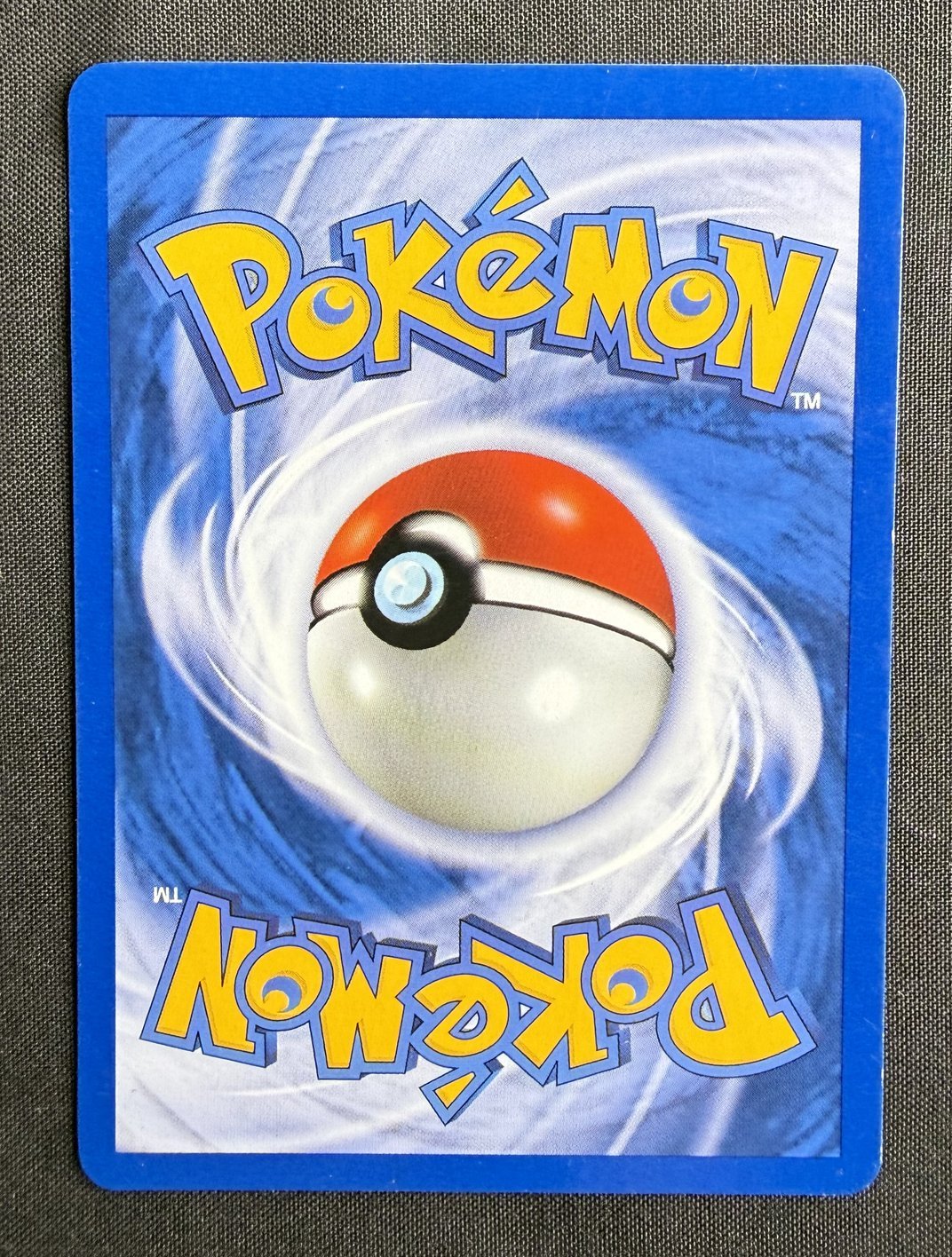 Back of the 2000 Neo Genesis Meganium 1st Edition holo card 10/111, showing the standard blue Pokemon card back with centered Poke Ball