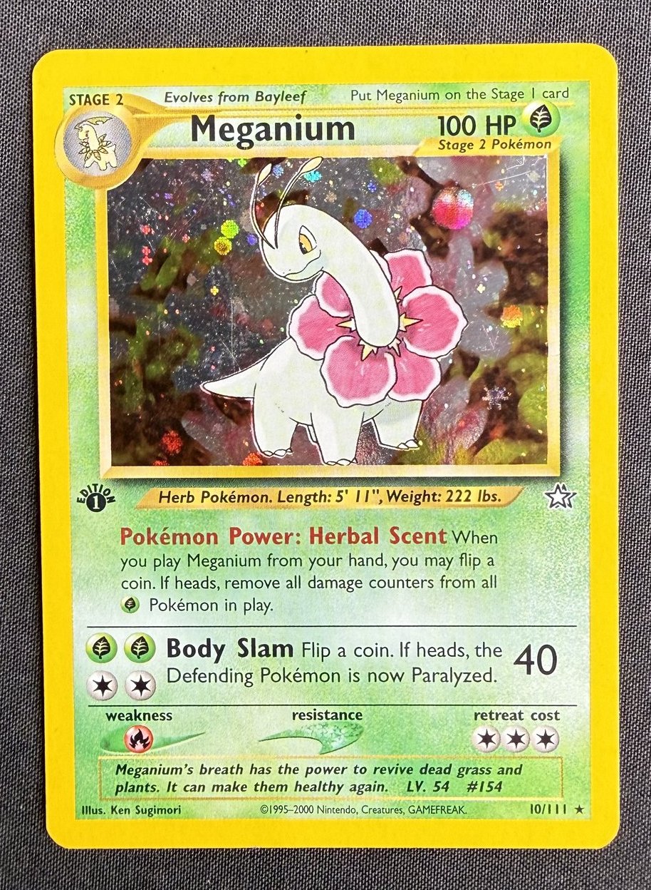 Front of a 2000 Pokemon Neo Genesis Meganium 1st Edition holo card, number 10/111, showing the Herb Pokemon on a holofoil background