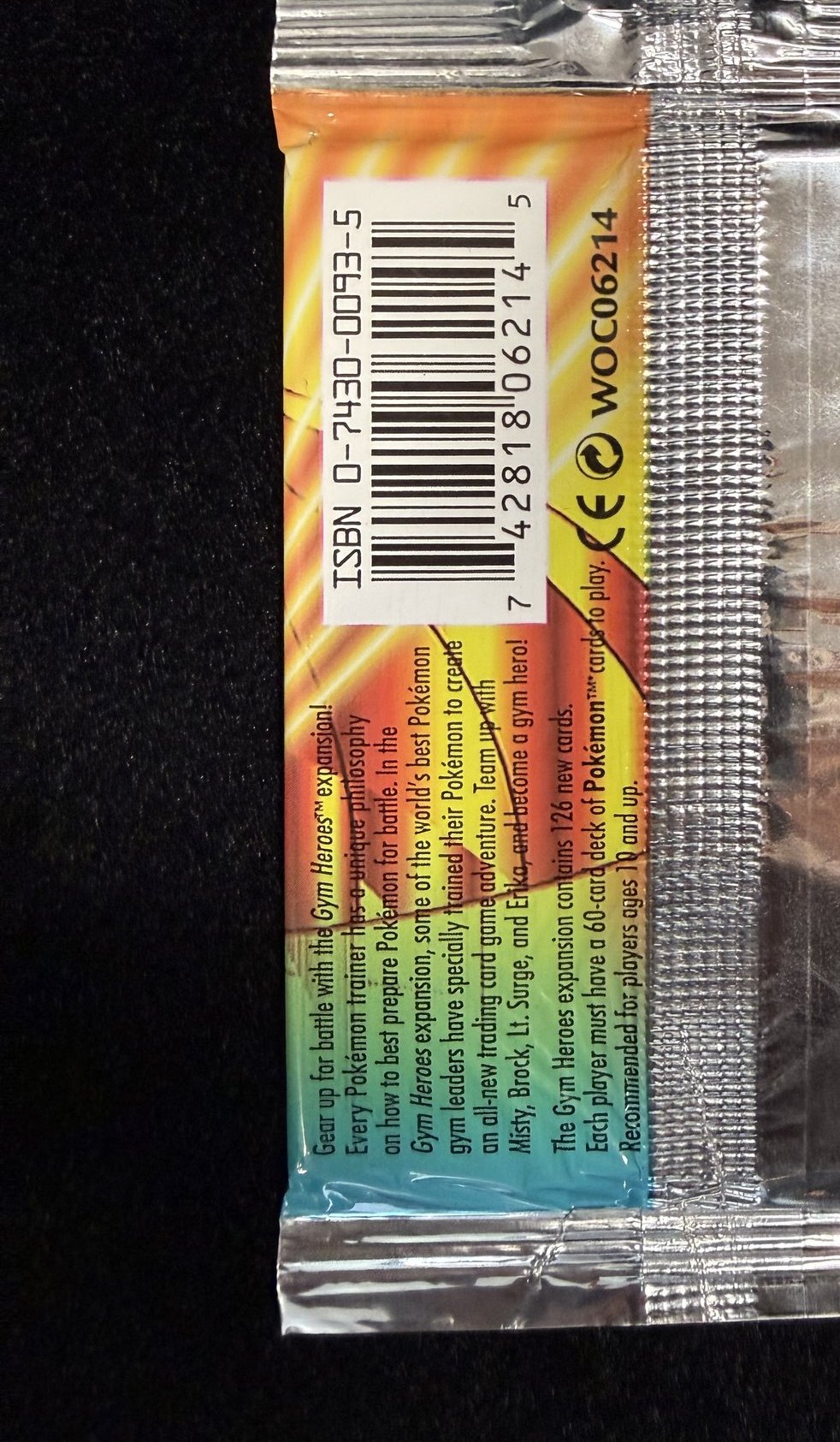 Back of the sealed 2000 Gym Heroes booster pack showing the barcode, WOC06214 product code and Wizards of the Coast and Nintendo licensing marks