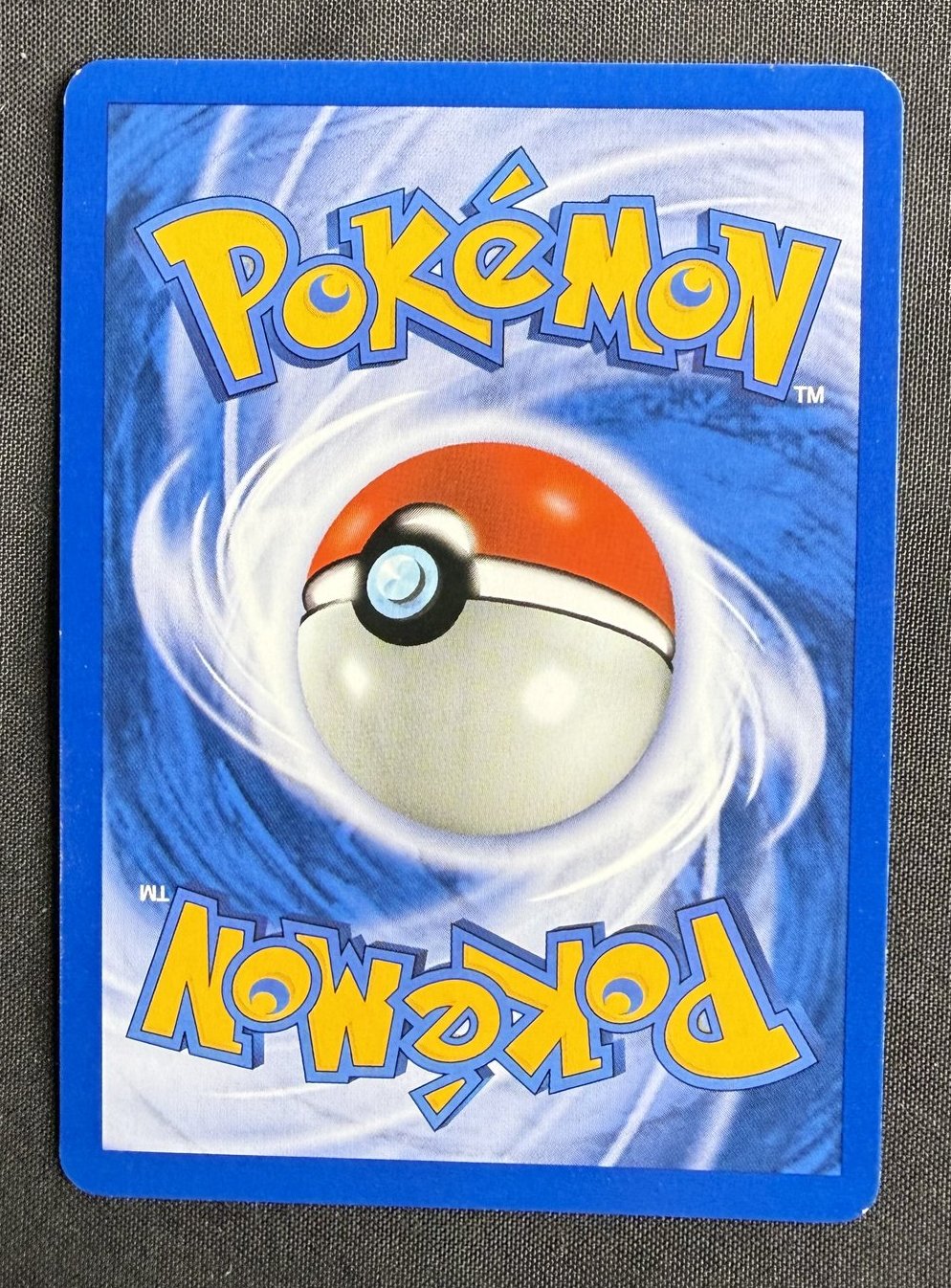 Back of the 2001 Neo Revelation Misdreavus 1st Edition holo card 11/64, showing the standard blue Pokemon card back with centered Poke Ball