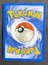 Back of the 2001 Neo Revelation Misdreavus 1st Edition holo card 11/64, showing the standard blue Pokemon card back with centered Poke Ball