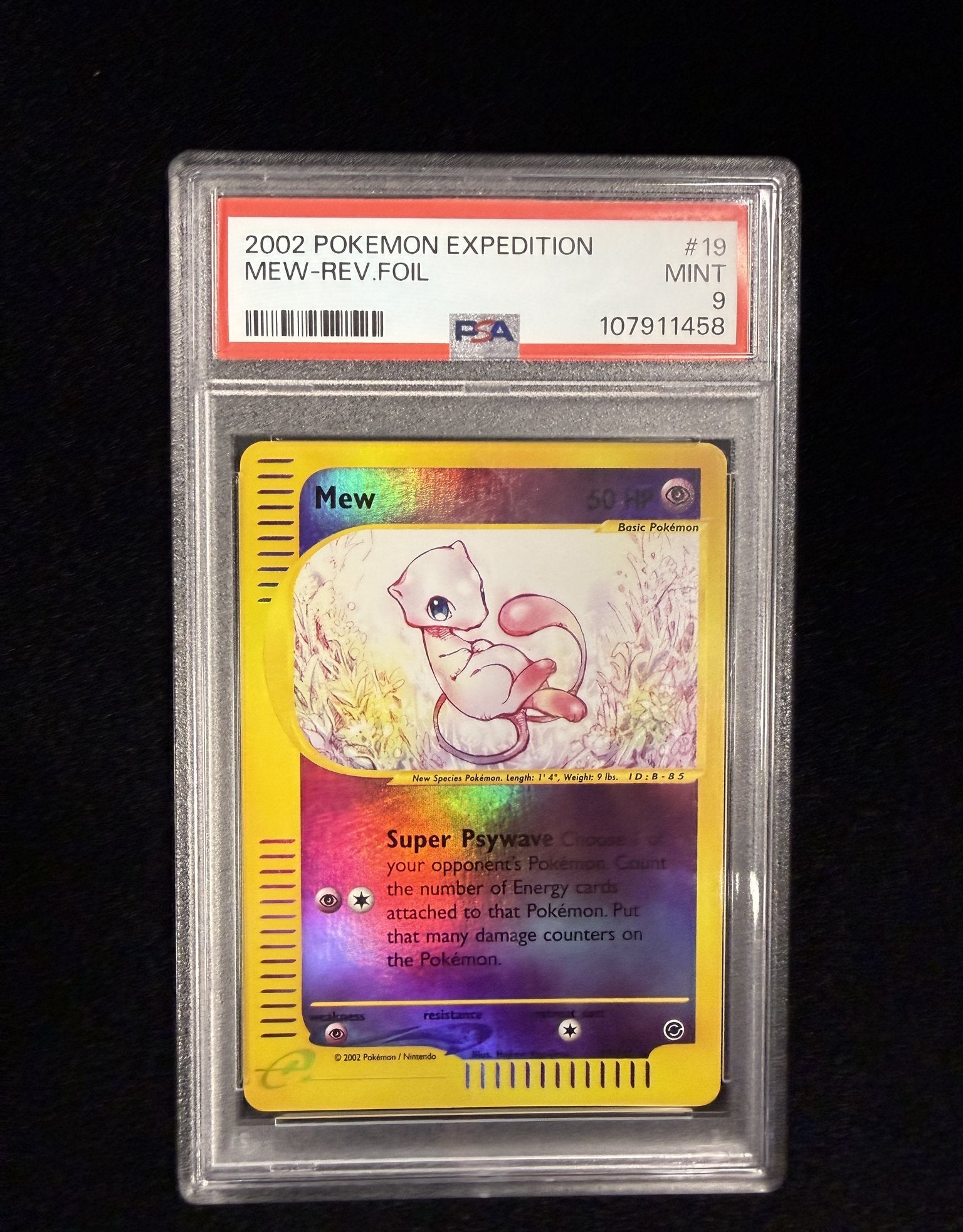 Front of a PSA 9 graded 2002 Pokemon Expedition Mew reverse holo card 19/165 in its PSA slab, label reading MINT 9 with cert number 107911458