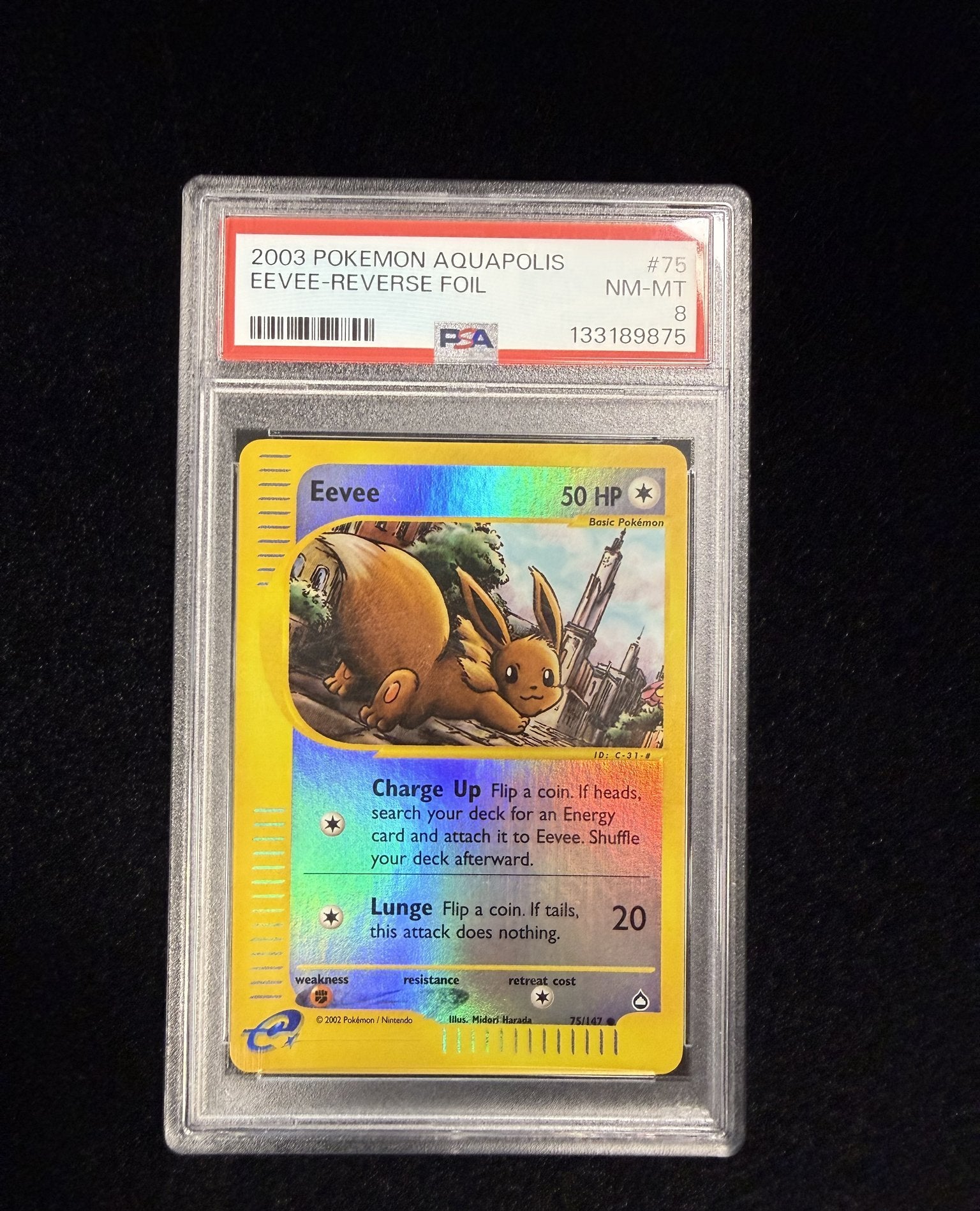 Front of a PSA 8 graded 2003 Pokemon Aquapolis Eevee reverse holo card 75/147 in its PSA slab, label reading NM-MT 8 with cert number 133189875